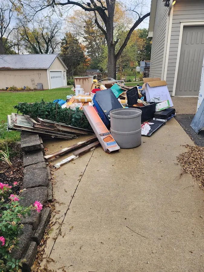 Dumpster being loaded with debris for 30 Yard Dumpster Rental in Russellville